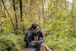 Man got journey on the forest going to peak mountain on Semarang Central Java. The photo is suitable to use for adventure content media, nature poster and forest background.