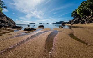 Tropical beach with rocks in West Sumatra coast, Indonesia photo