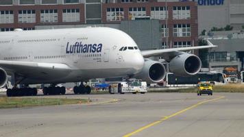 FRANKFURT AM MAIN, GERMANY JULY 17, 2017 - The tractor tows Lufthansa Airbus 380 D AIMH named  New York  to service. Fraport, Frankfurt, Germany video