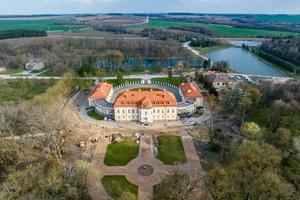 aerial view on overlooking restoration of the historic castle or palace near lake photo
