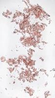 Vertical video of rose gold metalic paper particles blown by the wind, 15s perfect for social media stories