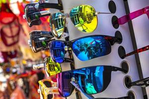 Playa del Carmen Quintana Roo MExico 2021 Colorful cool sunglasses at tourist sales stand in Mexico. photo