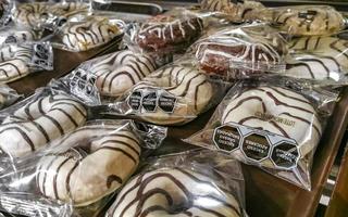 Puerto Escondido Oaxaca 2023 Chocolate and sugar donuts in supermarket bakery shelf in Mexico. photo