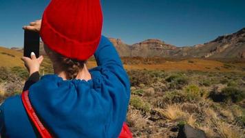 Active hiker woman hiking on Teide National Park and makes photo landscapes on the smartphone. Tenerife, Canary Islands video