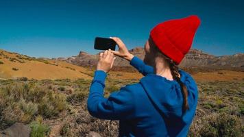 Active hiker woman hiking on Teide National Park and makes photo landscapes on the smartphone. Tenerife, Canary Islands video