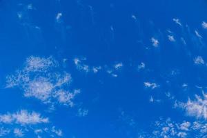 natural blue sky background on a sunny day with  clouds photo