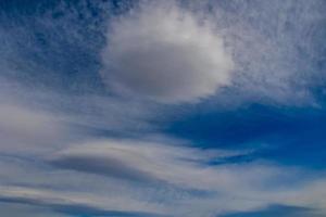 natural blue sky background on a sunny day with  clouds photo