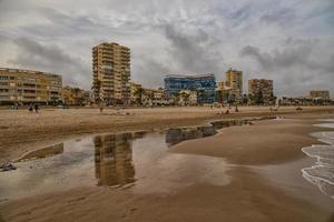 landscape wide sandy beach in alicante autumn day clouds photo