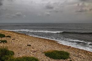 landscape empty rocky beach on a cloudy day spain photo