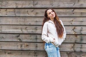 Happy girl smiling. Beauty portrait young happy positive laughing brunette woman on wooden wall background photo