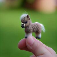 This is a cute mini horse the size of a thumb with a blurry. photo