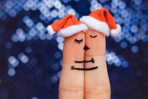 Couple kissing and hugging in the new year hats. photo