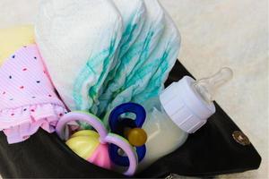 Women's handbag with items to care for the child photo