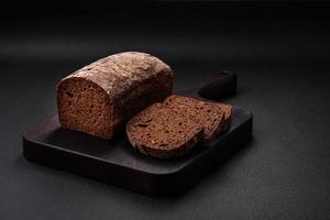 Loaf of fresh crispy brown bread with grains and seeds photo