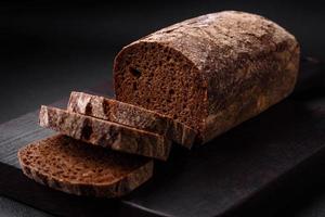 Loaf of fresh crispy brown bread with grains and seeds photo