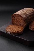 Loaf of fresh crispy brown bread with grains and seeds photo