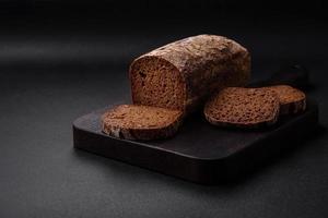 Loaf of fresh crispy brown bread with grains and seeds photo
