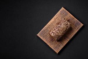 Loaf of fresh crispy brown bread with grains and seeds photo