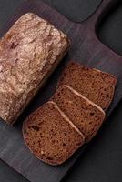 Loaf of fresh crispy brown bread with grains and seeds photo