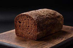 Loaf of fresh crispy brown bread with grains and seeds photo