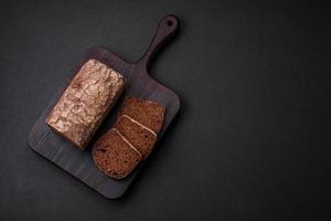 Loaf of fresh crispy brown bread with grains and seeds photo