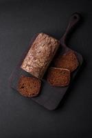 Loaf of fresh crispy brown bread with grains and seeds photo