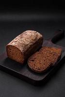 Loaf of fresh crispy brown bread with grains and seeds photo