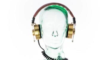 a clear glass mannequin head with amazing changing collection of vintage headphones spinning video