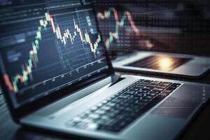Trading market and economic concepts with a laptop on the office desk. Modern share market and trade companies work with graph charts. Finance and trading graph chart hologram. . photo