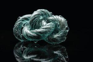 A big rope knot in the water with reflections created with technology. photo