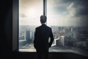 A businessman seen from behind is looking out of an office window in the big city created with technology. photo