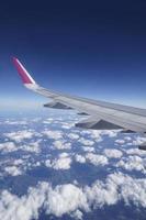 Flying Plane - Wing and Clouds photo