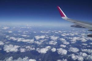 Flying Plane - Wing and Clouds photo