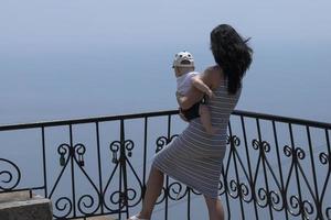 Woman Mother and boy on the observation deck against the background of the sky and sea. photo