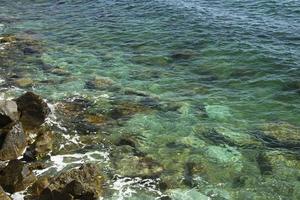 The shoreline of the sea with large stones. photo