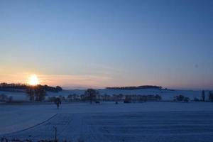 Sunrise in Snow Covered Hills photo