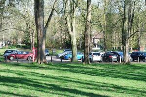 Gorgeous View of Wardown Public Park and People are Enjoying the Beautiful and Bright Sunny Day. They are Spending Day with Their Families and Having Fun. Image Was Captured at Luton on 03-April-2023 photo