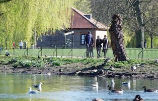 Gorgeous View of Wardown Public Park and People are Enjoying the Beautiful and Bright Sunny Day. They are Spending Day with Their Families and Having Fun. Image Was Captured at Luton on 03-April-2023 photo