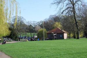 Gorgeous View of Wardown Public Park and People are Enjoying the Beautiful and Bright Sunny Day. They are Spending Day with Their Families and Having Fun. Image Was Captured at Luton on 03-April-2023 photo