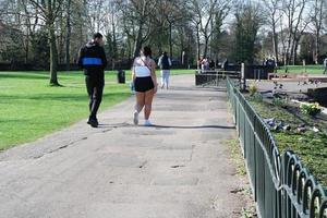 Gorgeous View of Wardown Public Park and People are Enjoying the Beautiful and Bright Sunny Day. They are Spending Day with Their Families and Having Fun. Image Was Captured at Luton on 03-April-2023 photo