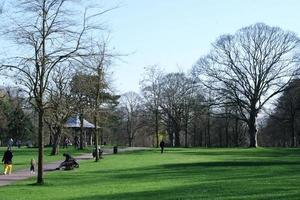 Gorgeous View of Wardown Public Park and People are Enjoying the Beautiful and Bright Sunny Day. They are Spending Day with Their Families and Having Fun. Image Was Captured at Luton on 03-April-2023 photo