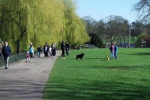 Gorgeous View of Wardown Public Park and People are Enjoying the Beautiful and Bright Sunny Day. They are Spending Day with Their Families and Having Fun. Image Was Captured at Luton on 03-April-2023 photo