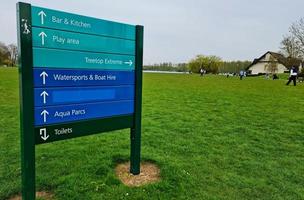 Low Angle View of Willen Lake and Public Park with Ferris Wheel for Fun. People are Enjoying the Start of Summer Season at this Park of Milton Keynes England UK. Footage was Captured on 09-April-202 photo