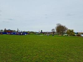 Gorgeous View of Wardown Public Park and People are Enjoying the Beautiful and Bright Sunny Day. They are Spending Day with Their Families and Having Fun. Image Was Captured at Luton on 03-April-2023 photo
