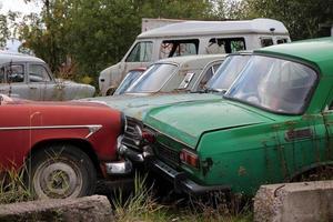 cemetery of old abandoned cars, at scrap yard photo