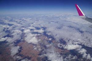 Flying Plane - Wing and Clouds photo