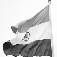 India flag flying high at Connaught Place with pride in blue sky, India flag fluttering, Indian Flag on Independence Day and Republic Day of India, tilt up shot, Waving Indian flag, Har Ghar Tiranga photo