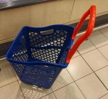 Blue and red Plastic shopping trolley,rolling basket,shopping basket with wheel top view photo