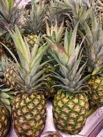 Fresh pineapples at supermarket fresh fruit market,raw pineapples photo