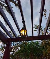 Decorative lamp hanging in the hut,beautiful view of clouds and sky through hut ,ramdaan traditional photo